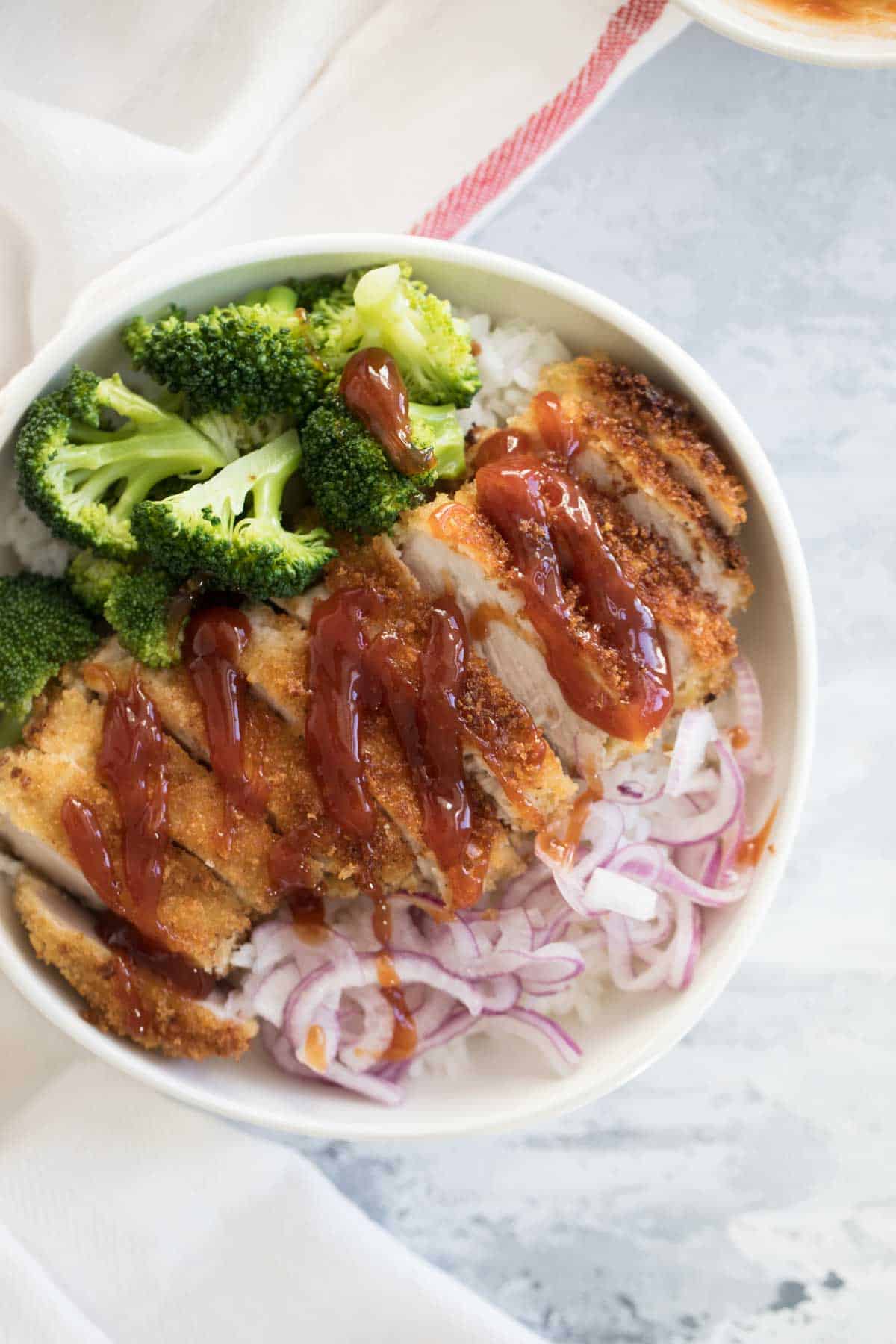 Rice bowls with sweet and sour pork, pickled onions and broccoli