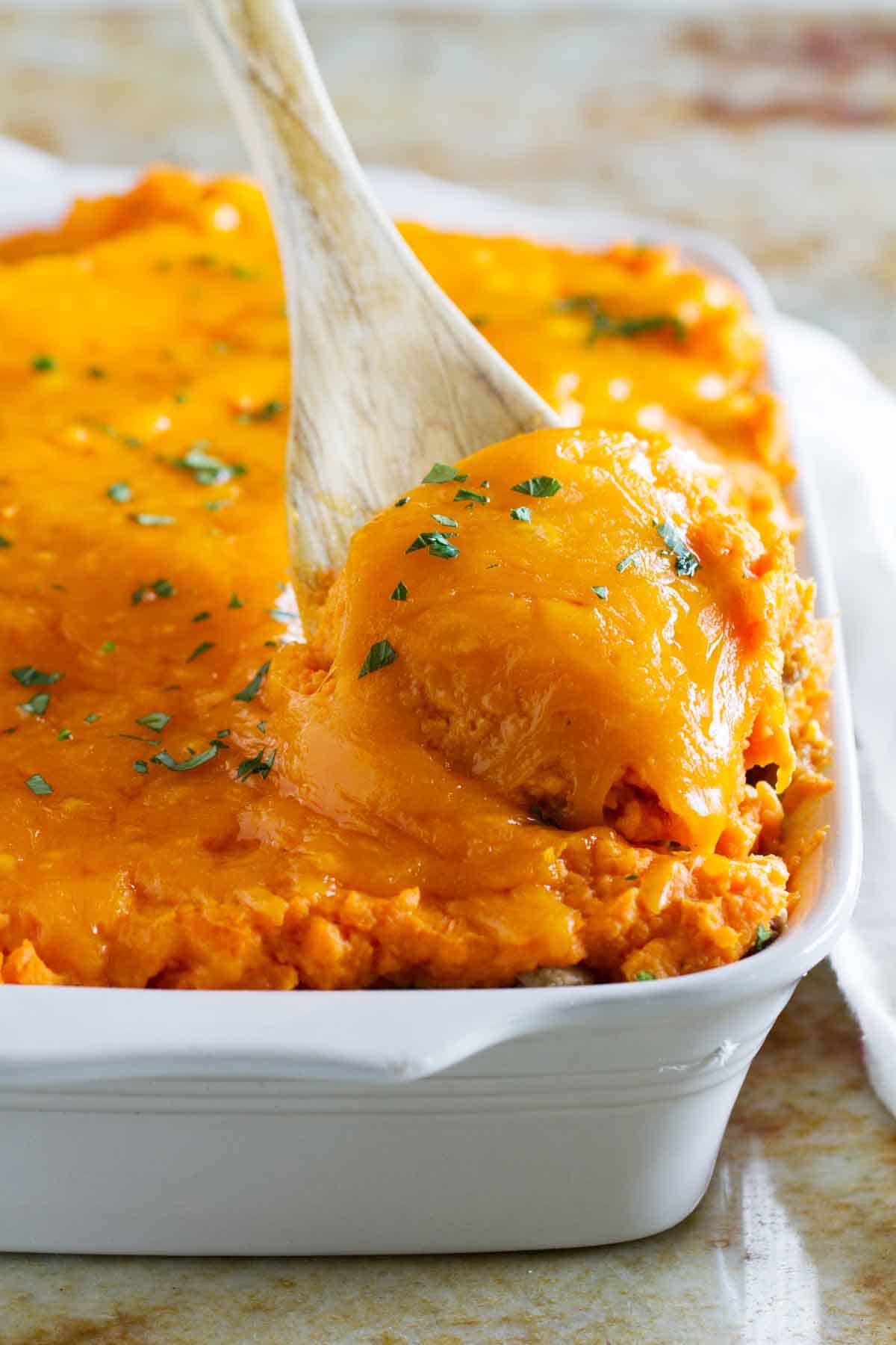 Scooping out a serving of Turkey Shepherd's Pie with Sweet Potatoes.