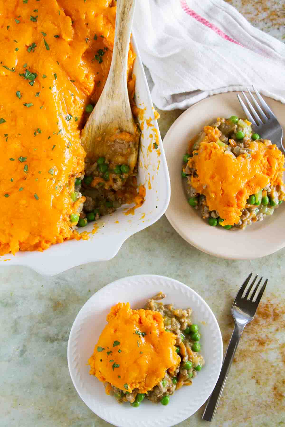 Servings of Turkey Shepherd's Pie with Sweet Potatoes on two plates.