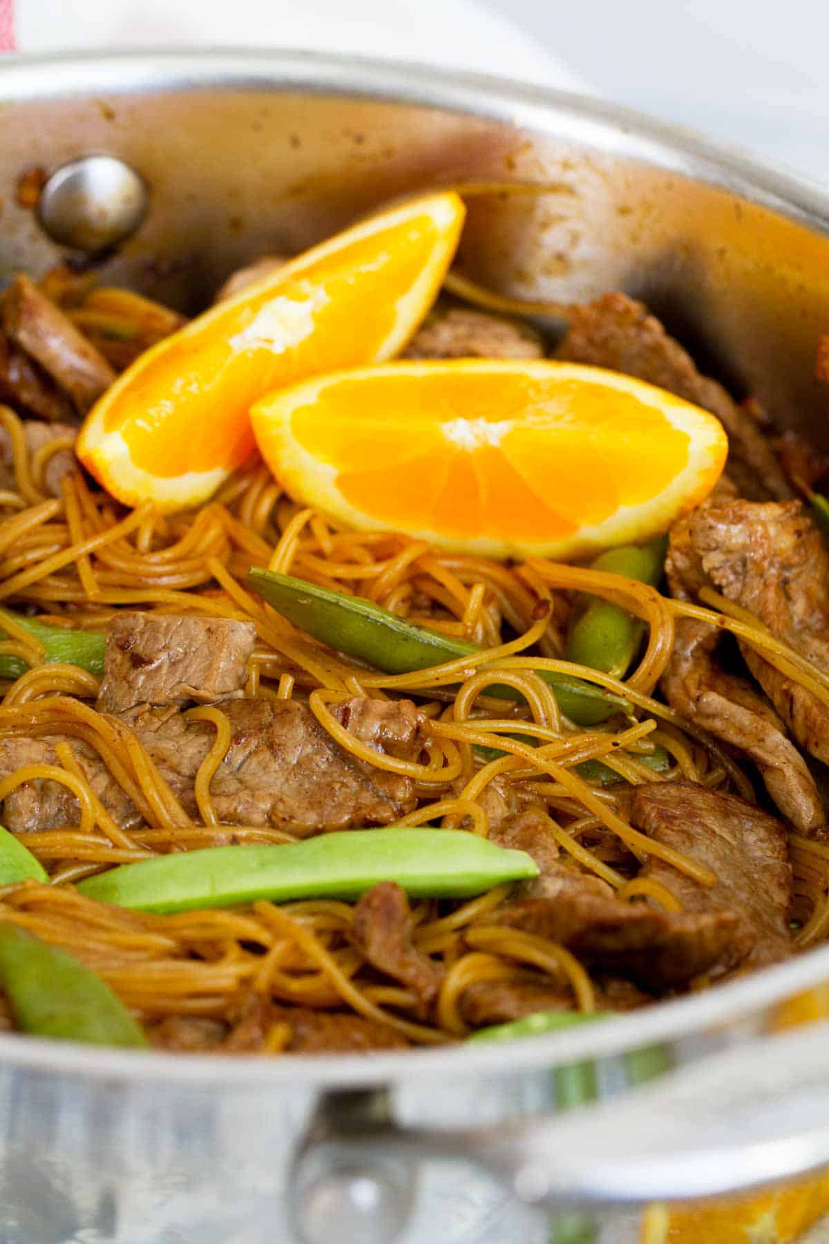 Orange Teriyaki Beef and Noodles topped with fresh oranges. 