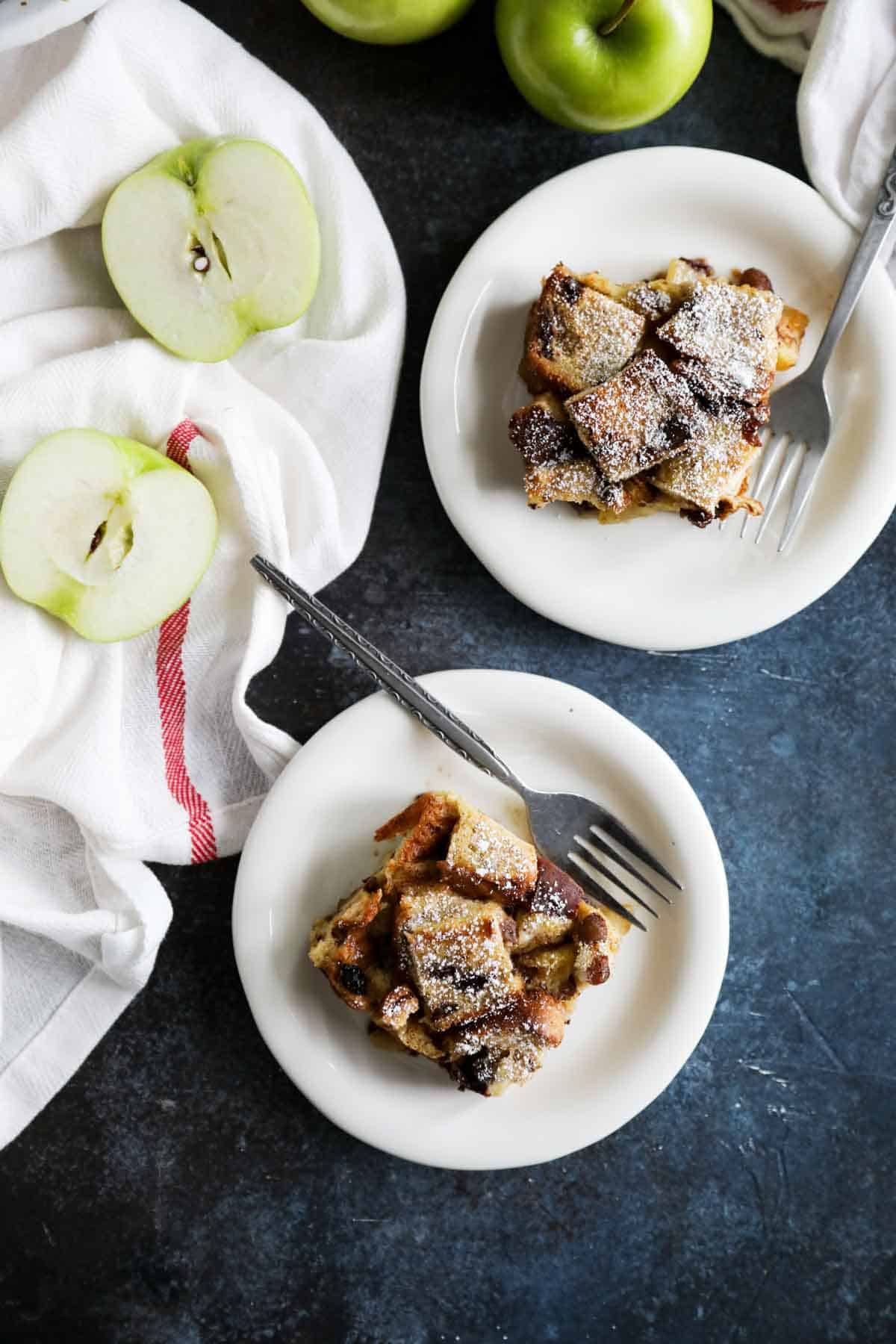 Servings of baked French Toast Casserole with apples on plates.