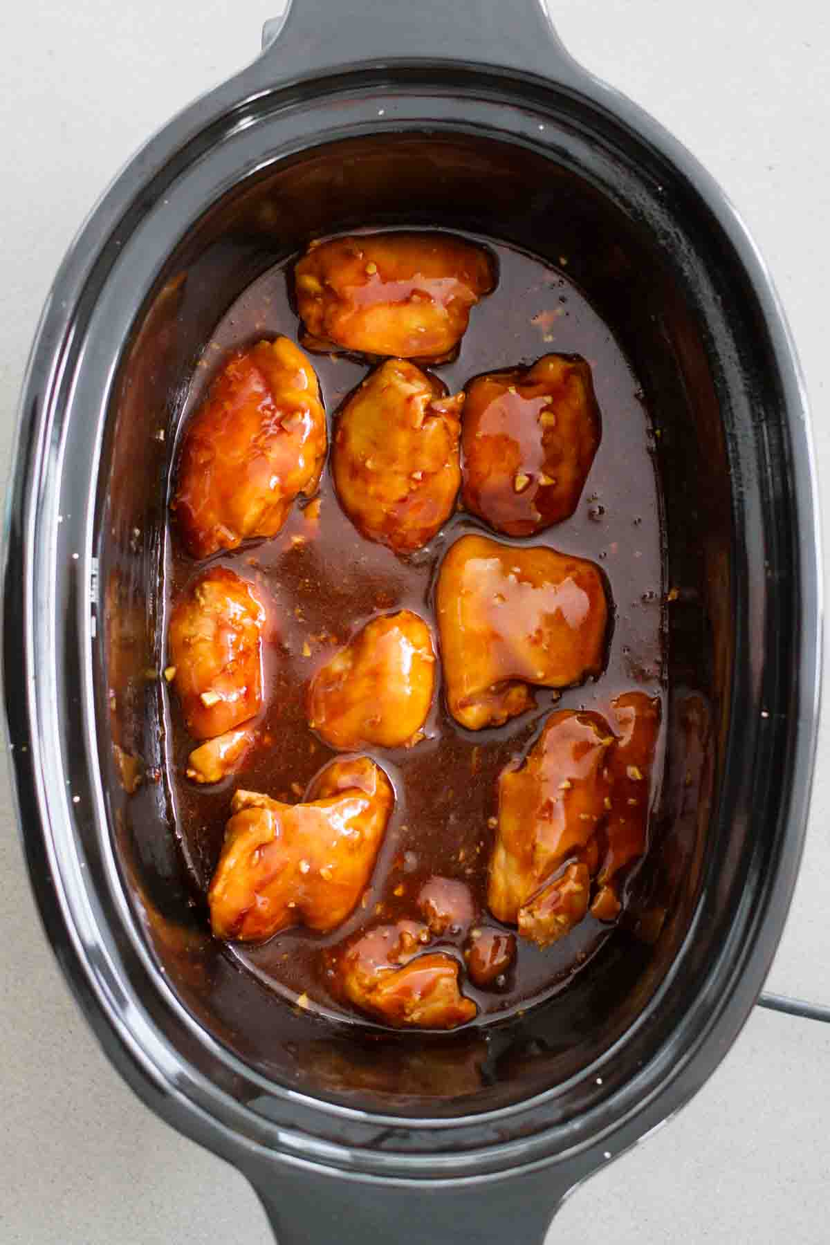 Slow cooker honey garlic chicken in a crockpot.