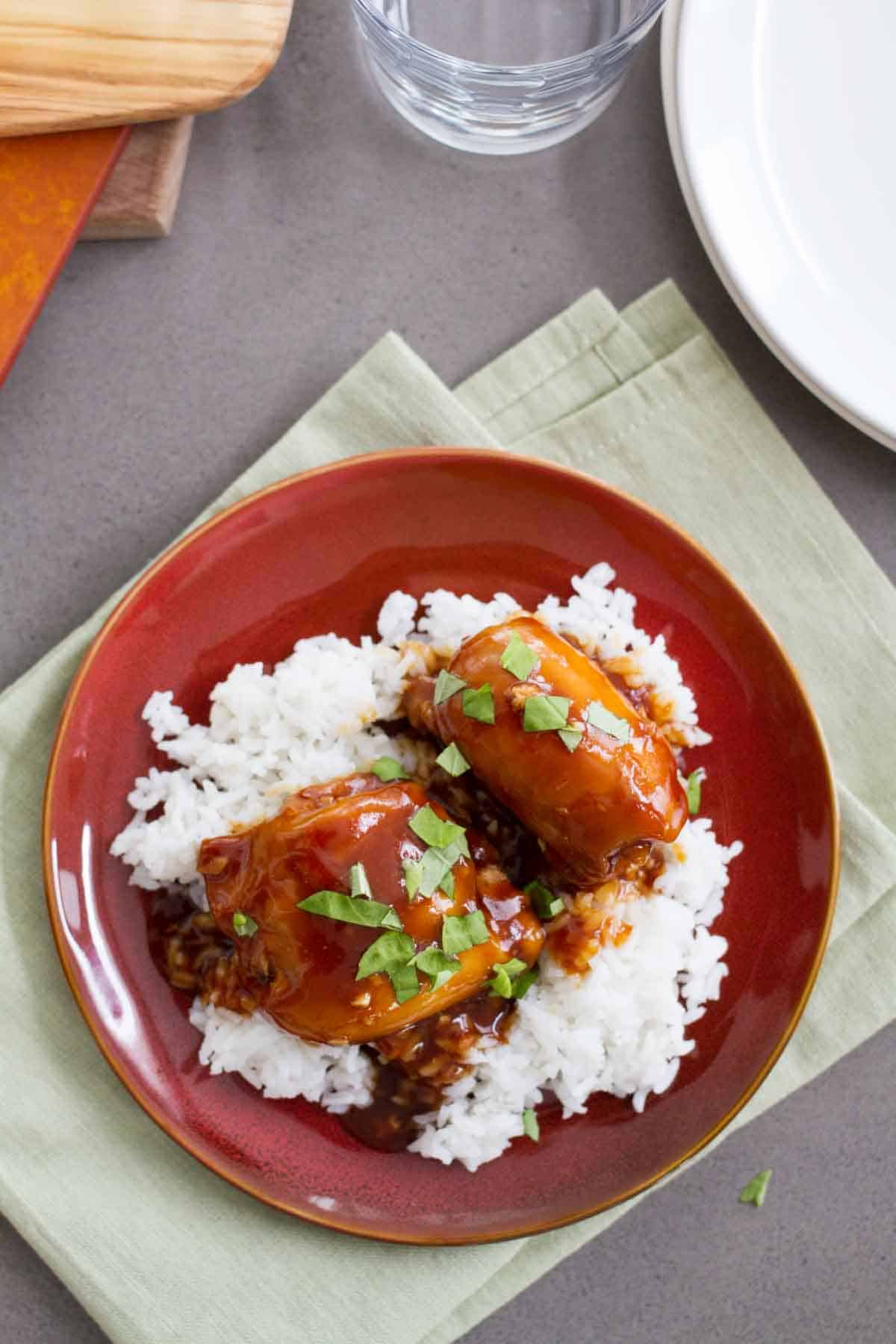 Slow Cooker Honey Garlic Chicken over rice, topped with basil.