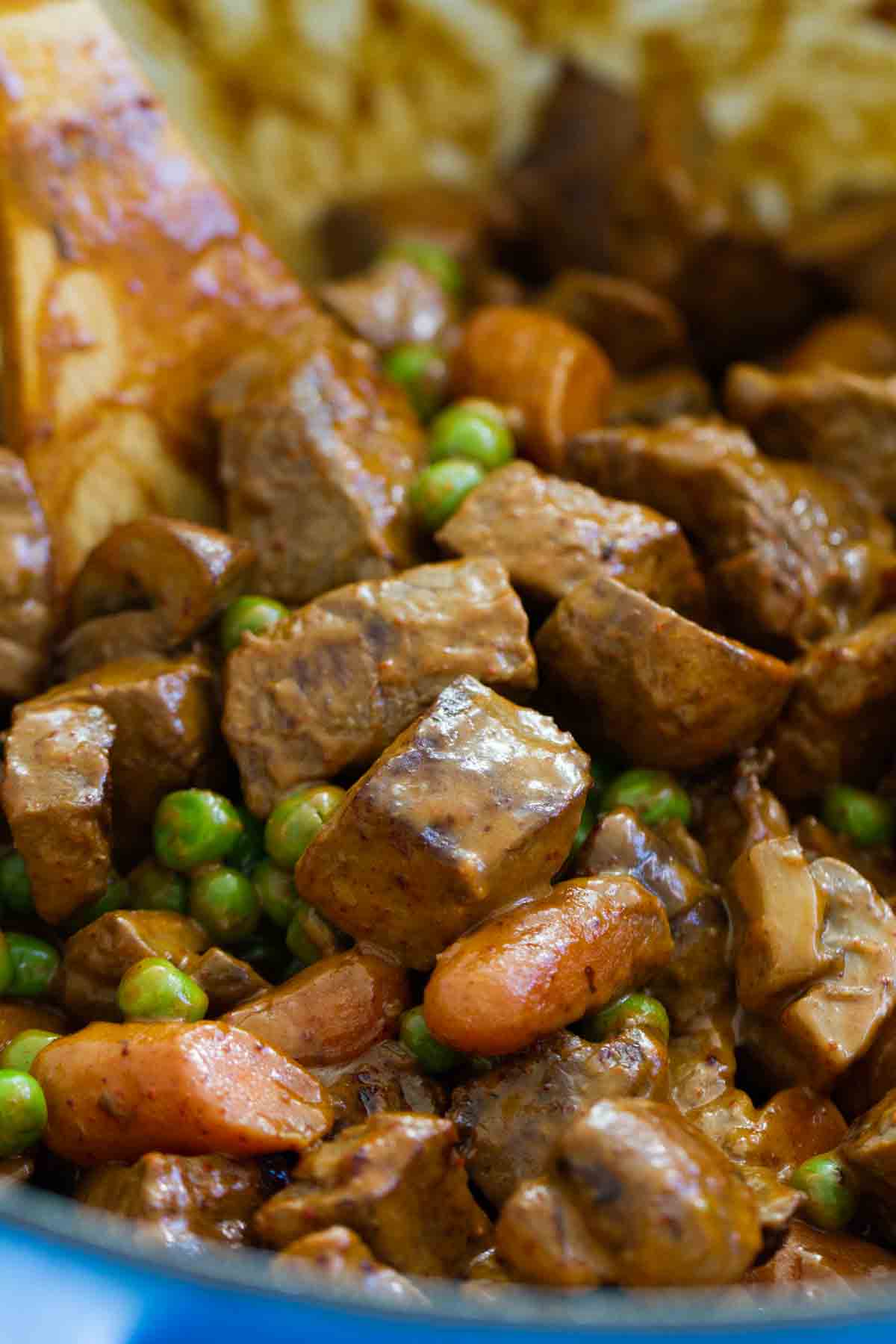 Chili Beef and Vegetables in a pot with a wooden spoon.