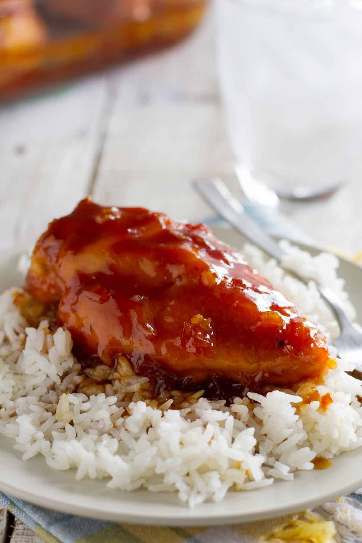 Piece of candied chicken served over rice.