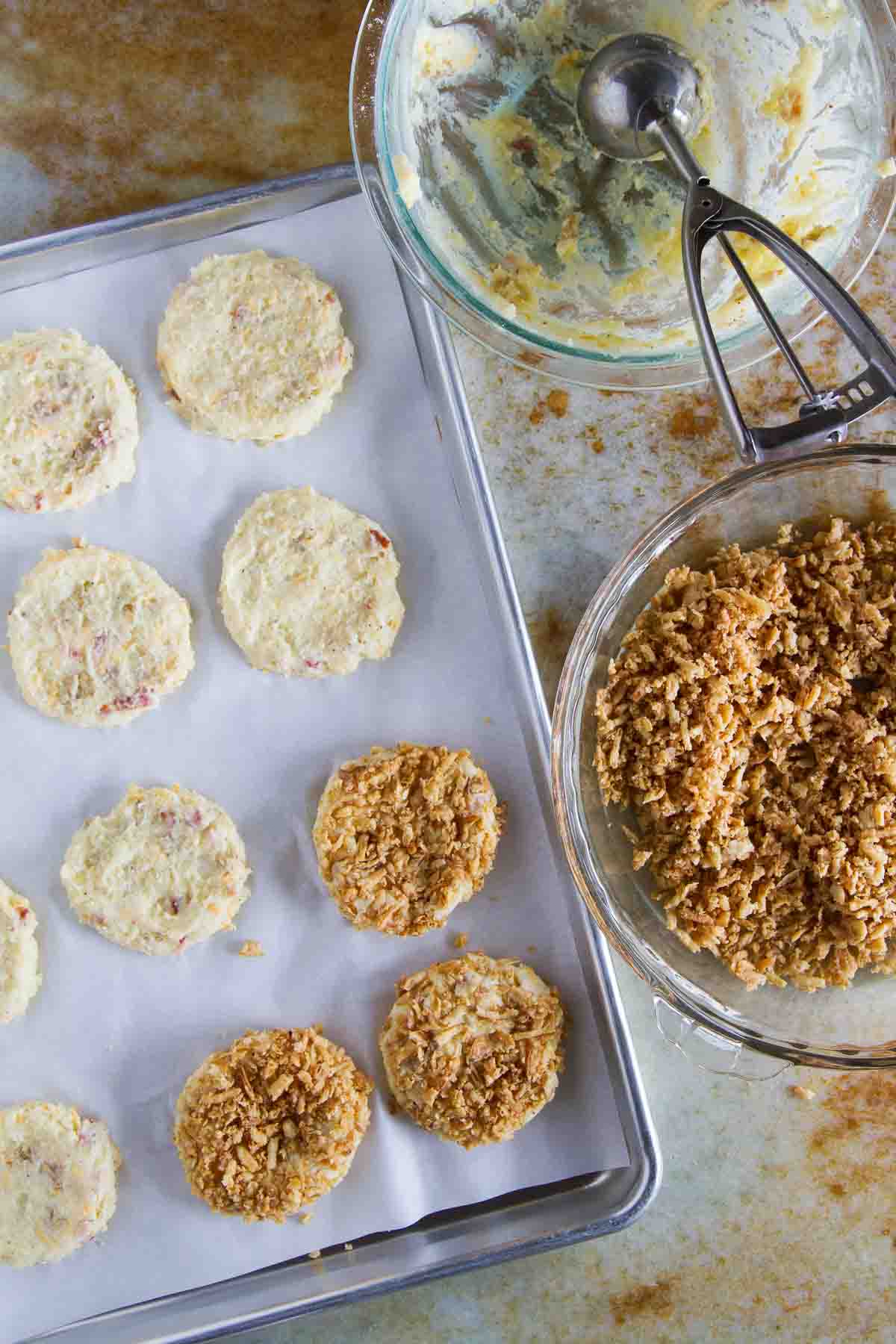 Scooping mashed potatoes and covering in french fried onions.