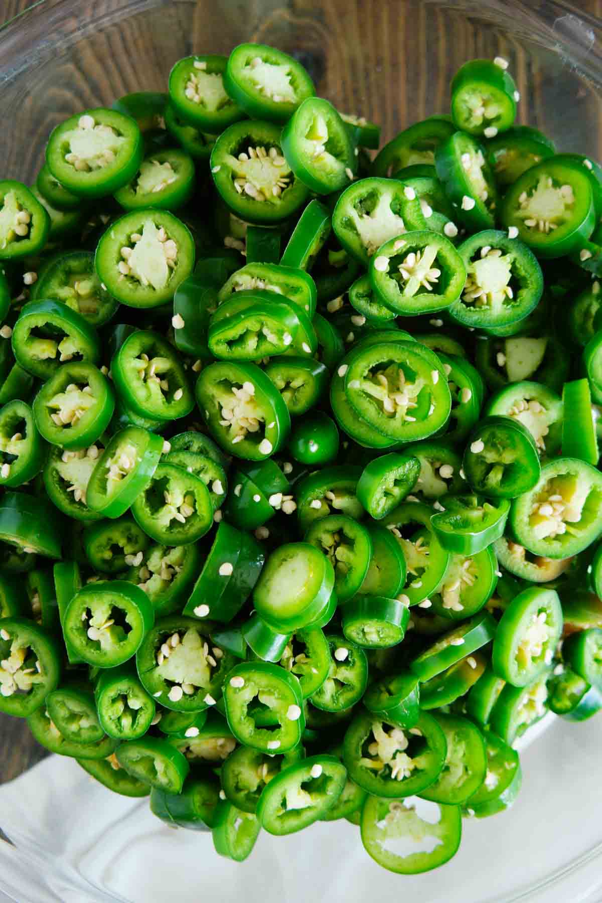 Raw jalapeños sliced in a bowl.