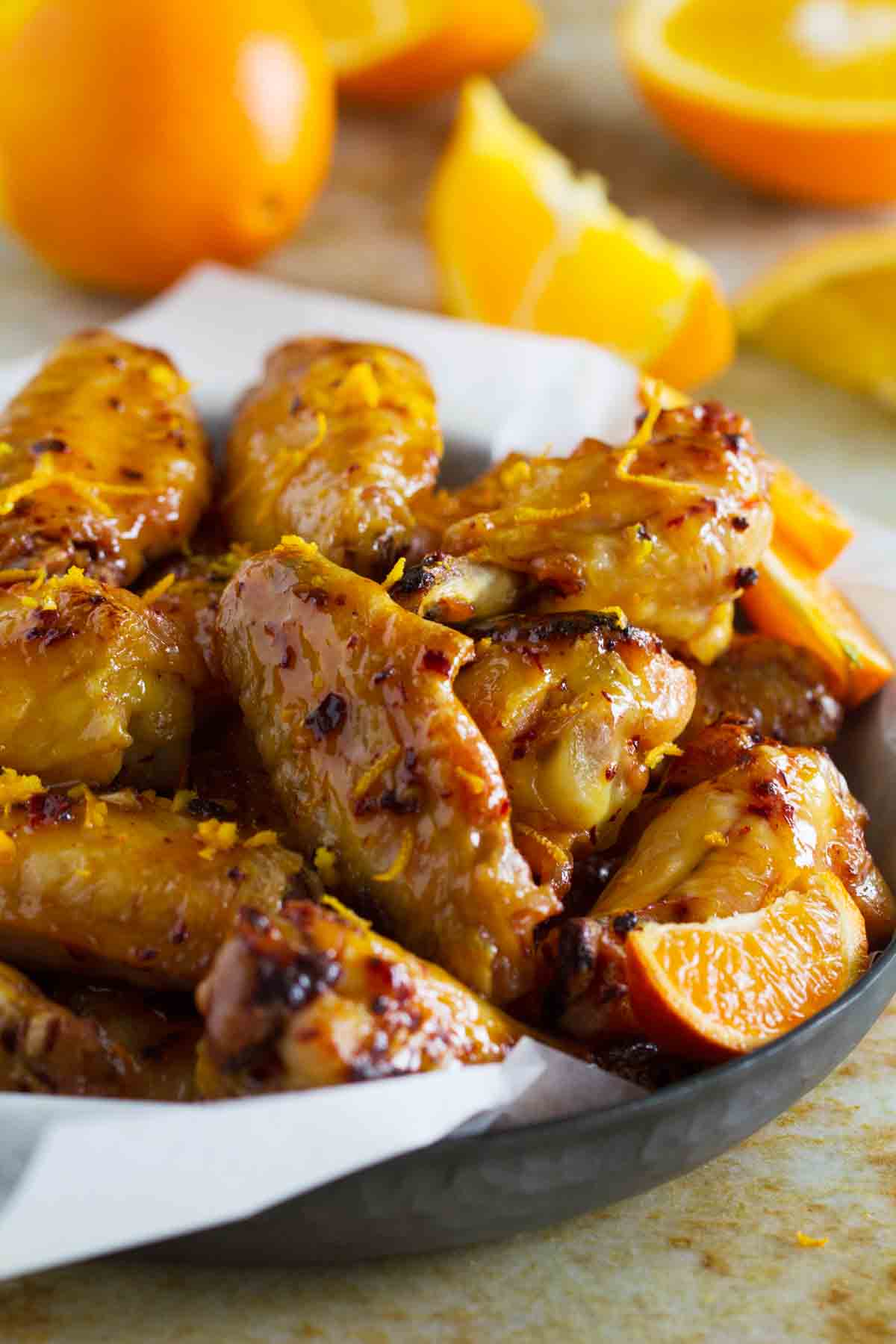 Chipotle Orange Chicken Wings with orange zest sprinkled on top.