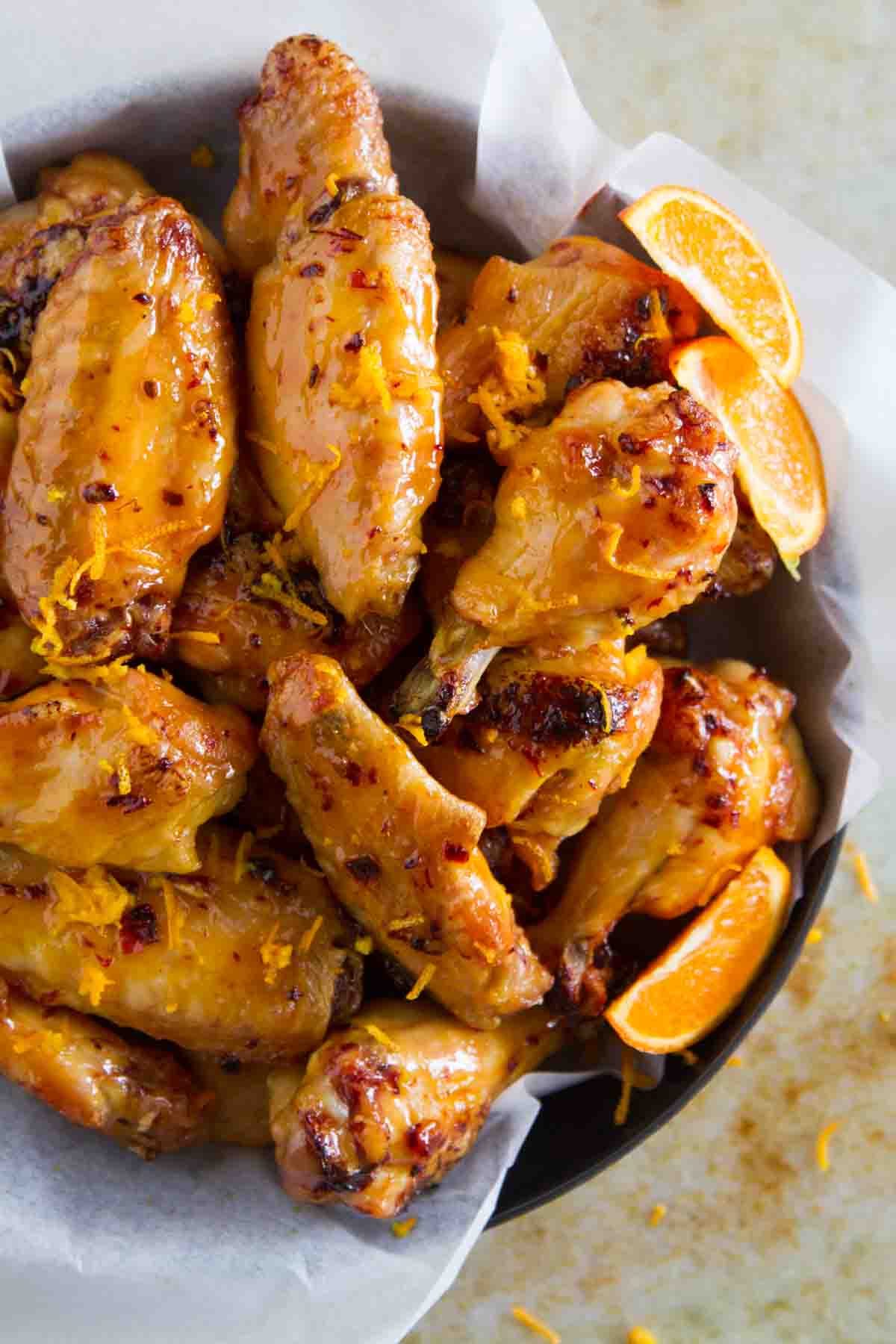 Chipotle Orange Chicken Wings stacked in a bowl.