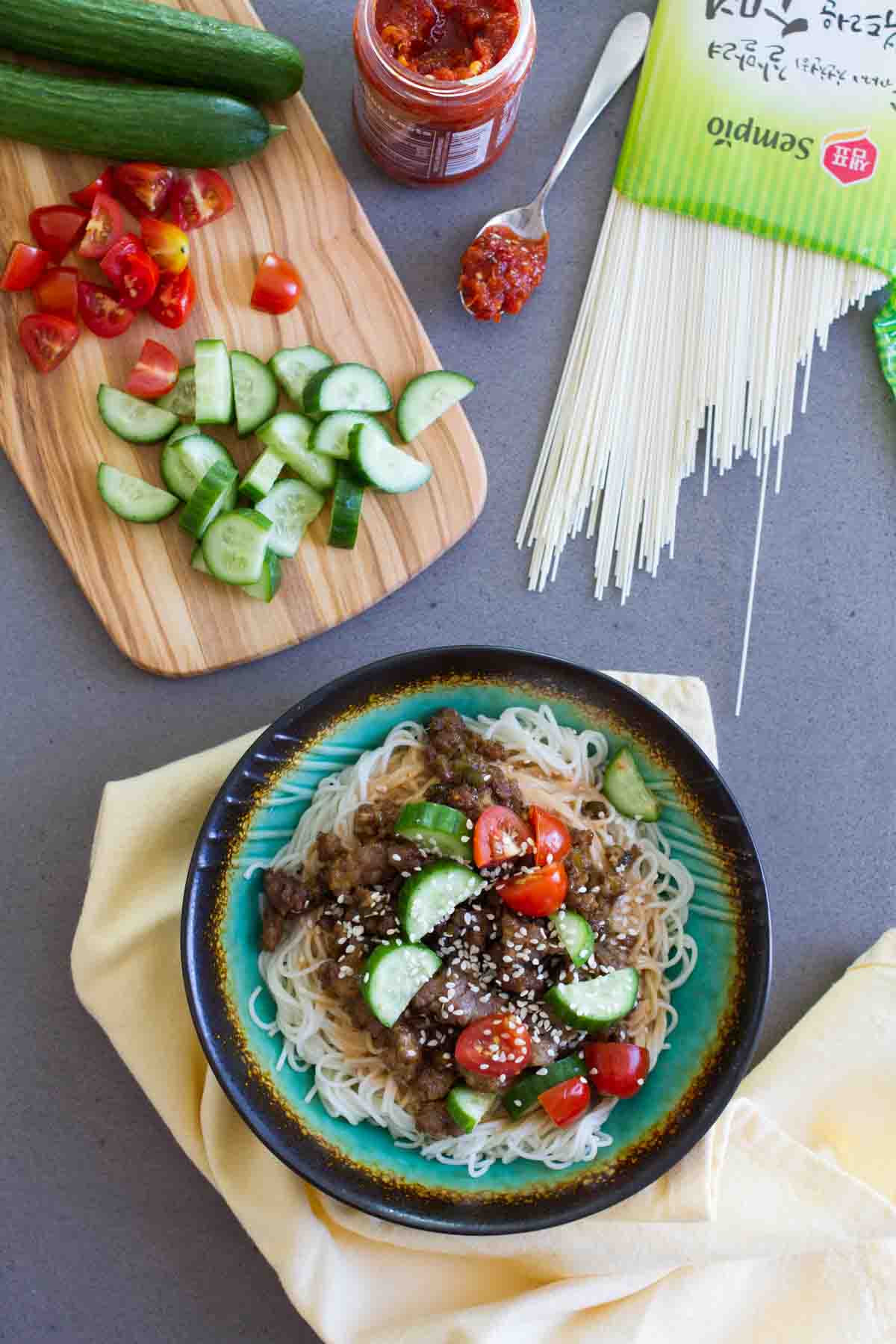 Spicy Pork Noodle Bowl with ground pork, fresh vegetables, and Chinese noodles.