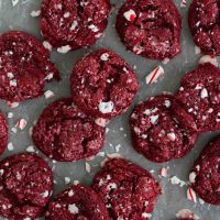 Red Velvet Peppermint Gooey Butter Cookies laid out with peppermint pieces.