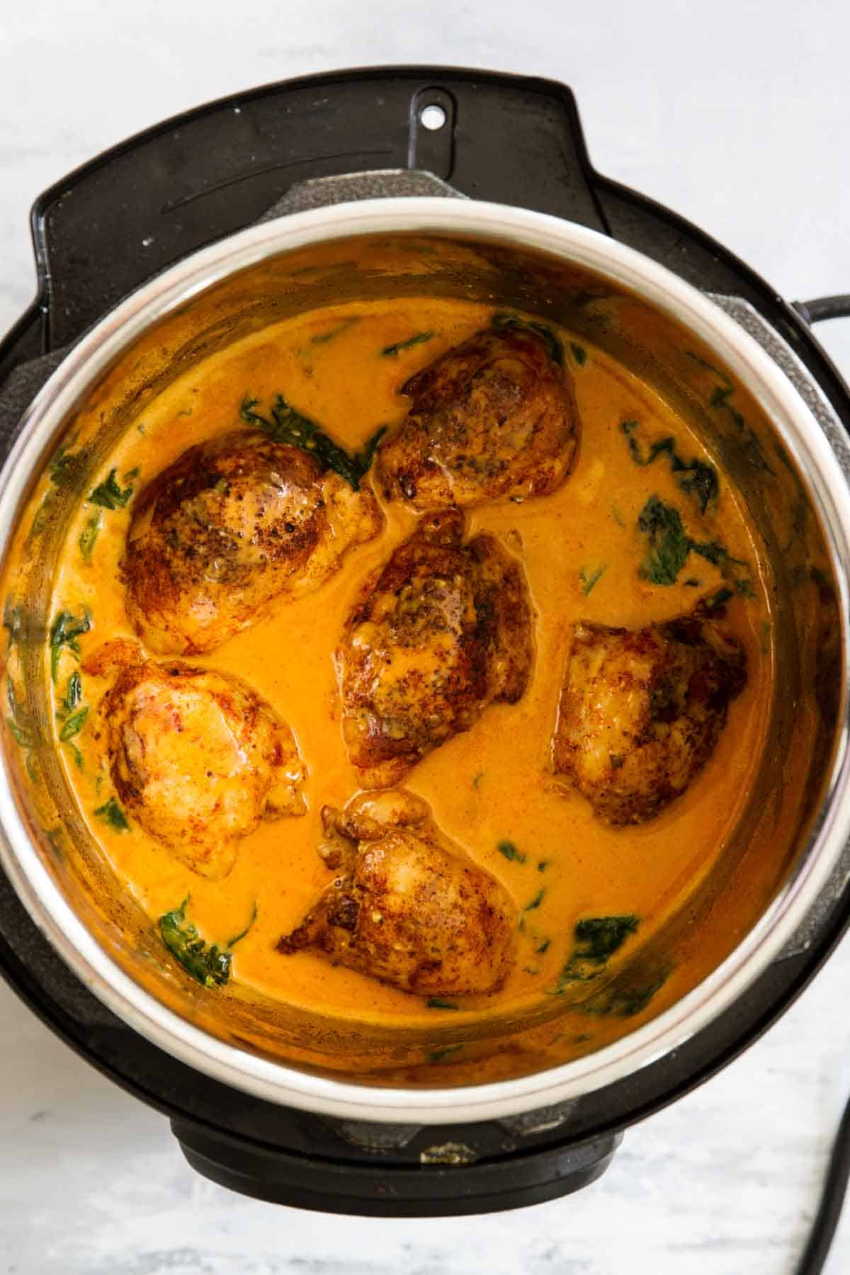 Garlic Paprika Instant Pot Chicken Thighs with sauce in an instant pot.