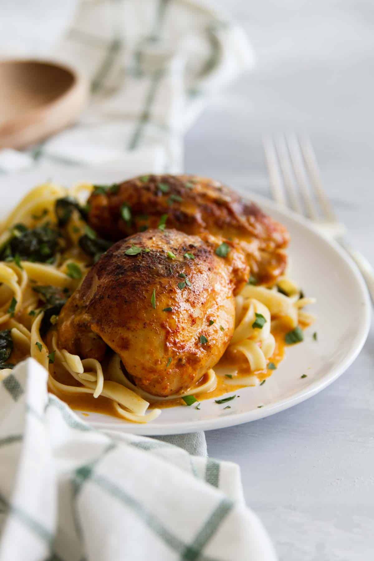 Pressure Cooker Chicken Thighs with Garlic and Paprika with fresh herbs on top.