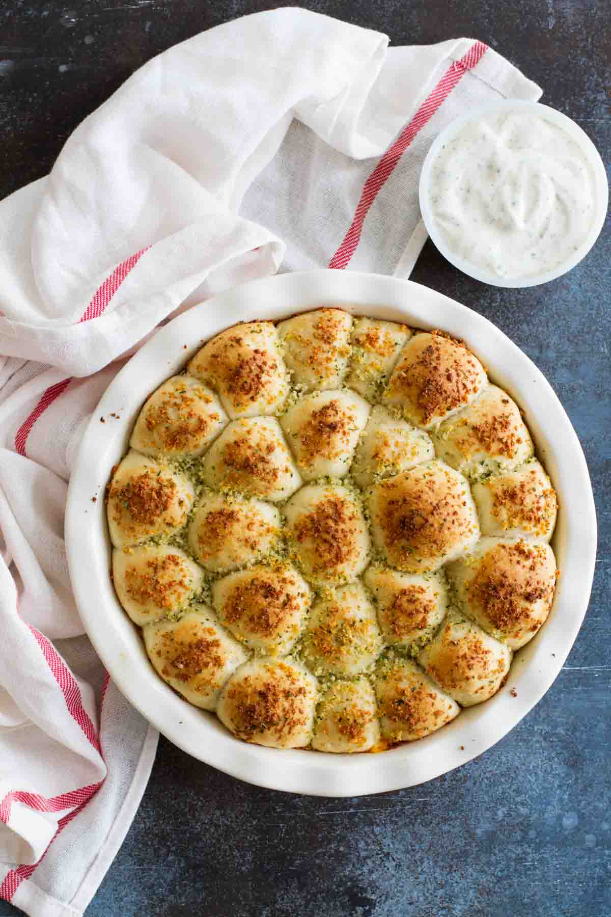 Stuffed Pizza Rolls in a dish with ranch dressing for dipping.