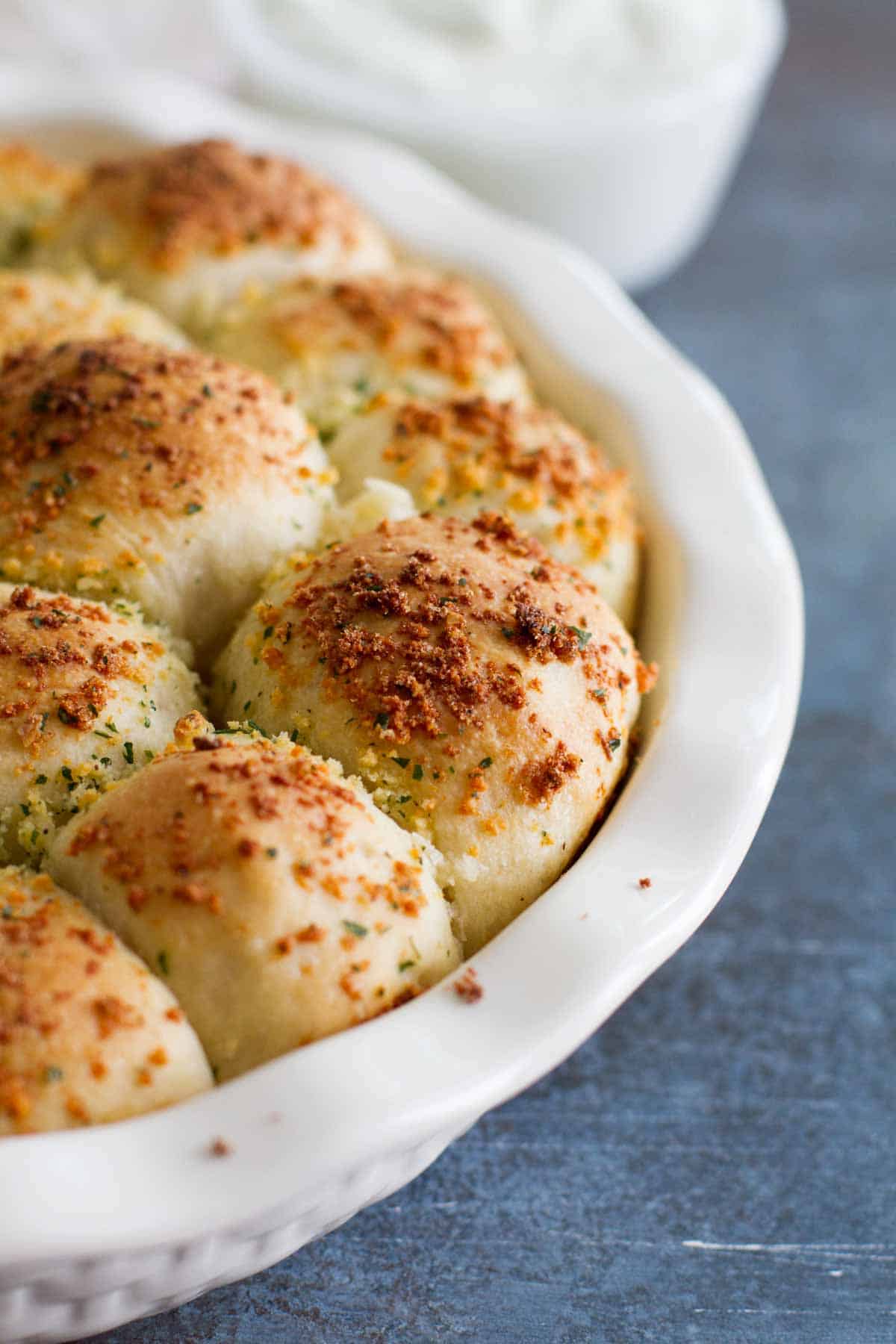 Close up of topping on top of stuffed pizza rolls.