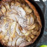 Overhead view of German Apple Pancake with apples on the side