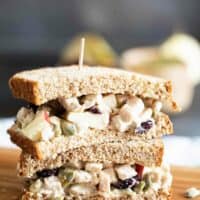 two half turkey salad sandwiches stacked on top of each other