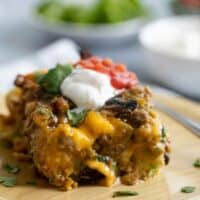 slice of sausage breakfast casserole on a wooden plate