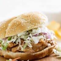 Slow Cooker Teriyaki Chicken Sandwich on a cutting board