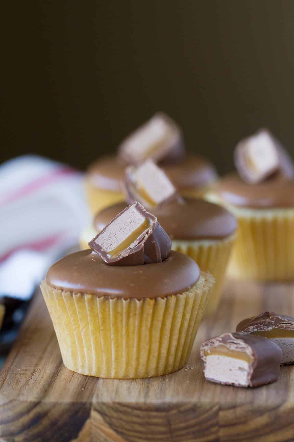 Milky Way cupcake topped with a piece of Milky Way candy bar.