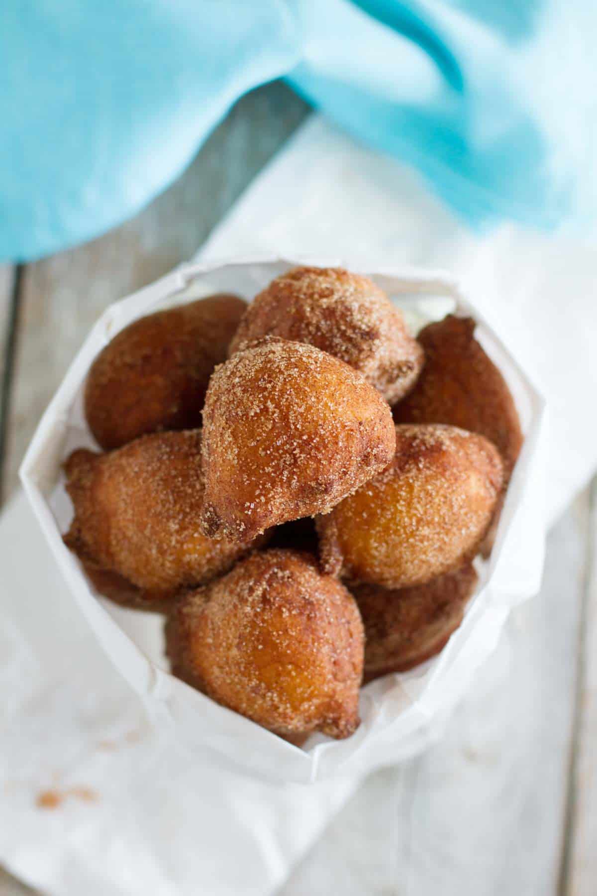 Paper bag filled with ricotta doughnuts.