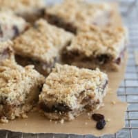 Oatmeal Raisin Bars on a cooling rack, with a bite taken from one bar.