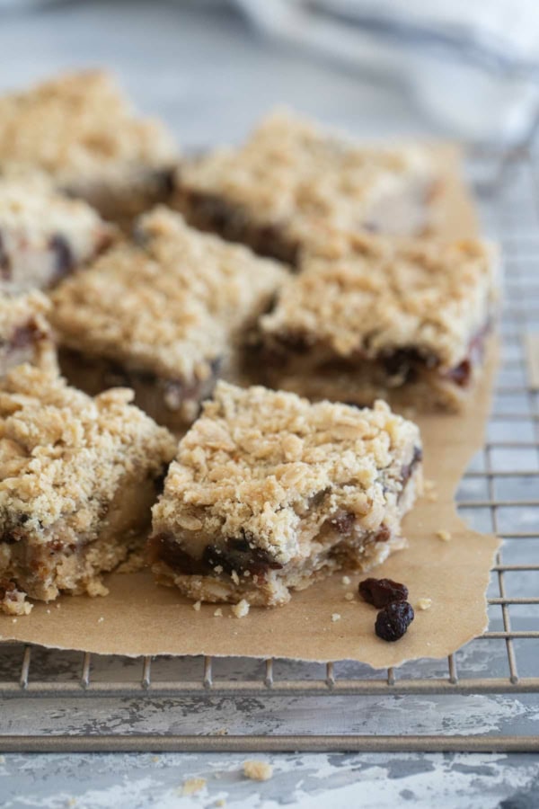 Oatmeal Raisin Bars on a cooling rack, with a bite taken from one bar.