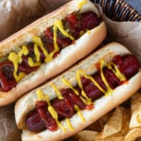 Two Air Fryer Hot Dogs with potato chips.