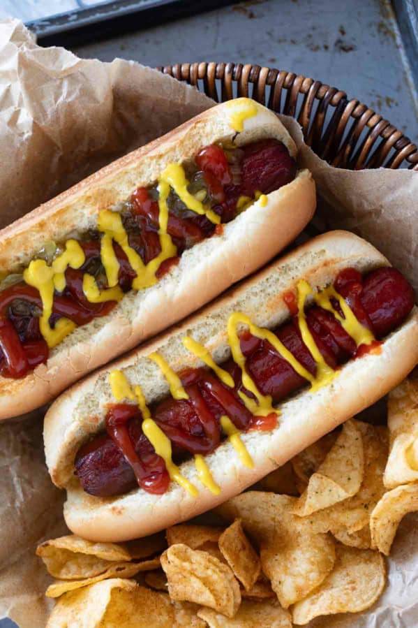 Two Air Fryer Hot Dogs with potato chips.