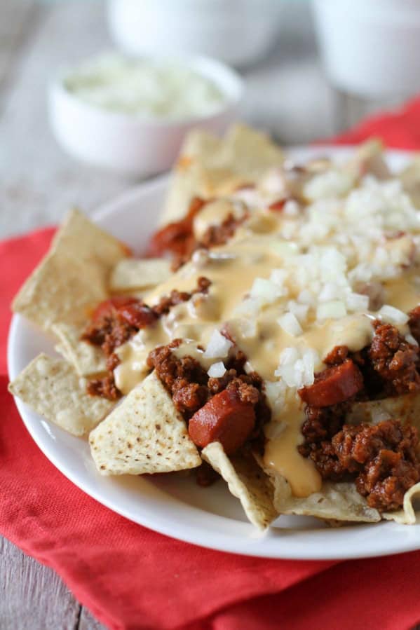 Chili Dog Nachos topped with hot dog filled chili and cheese sauce.