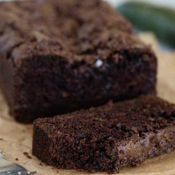 Slice of chocolate zucchini bread with a bite taken from it.