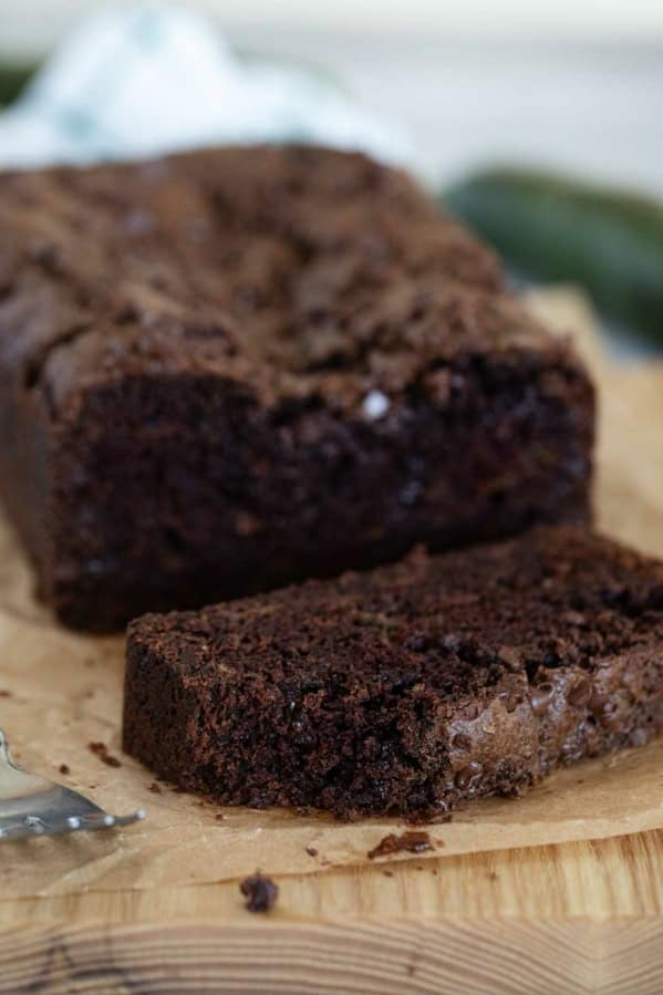 Slice of chocolate zucchini bread with a bite taken from it.