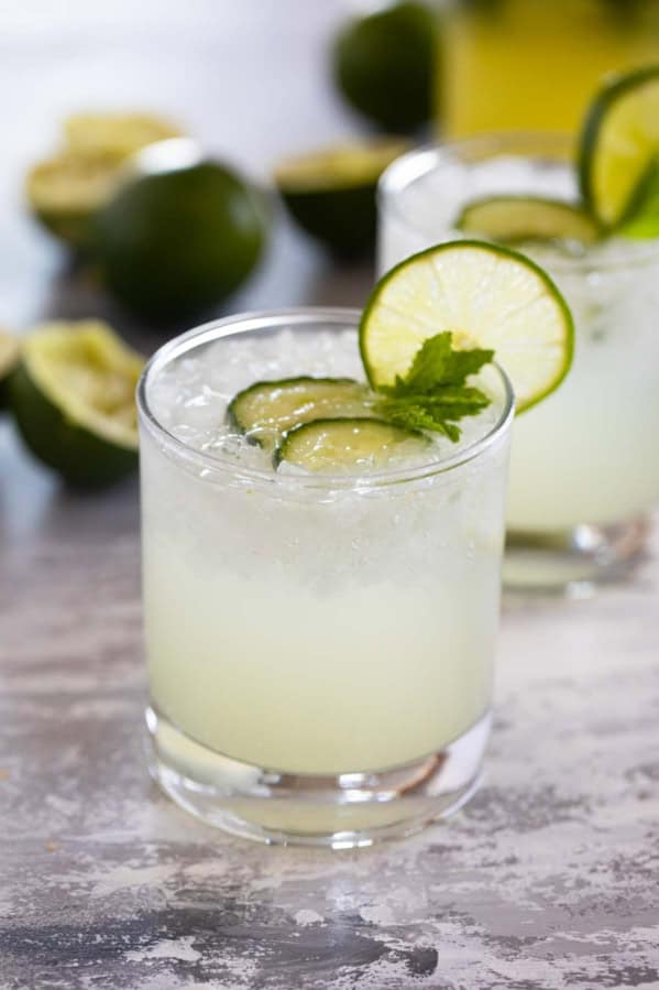 Glass of cucumber limeade with a lime slice on the glass.