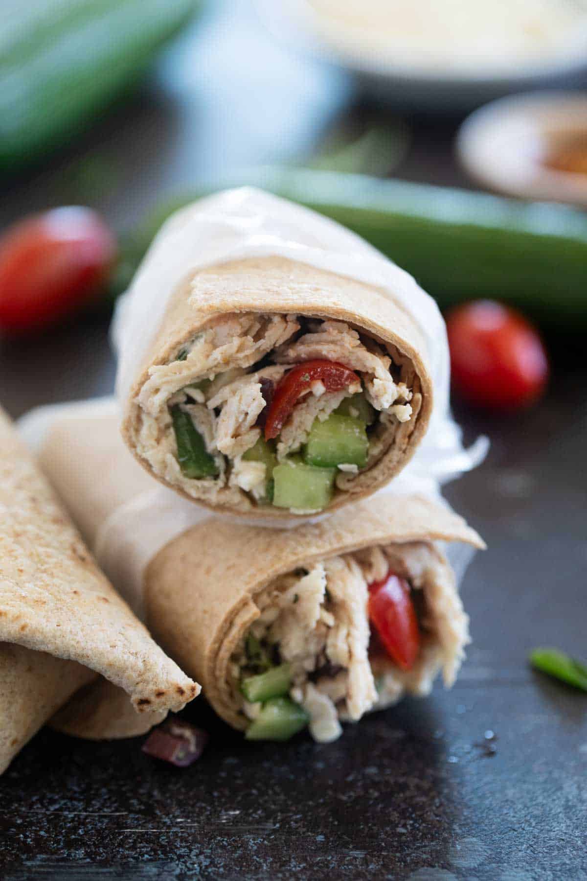 Greek Chicken Wraps with tomatoes, cucumbers, and olives.
