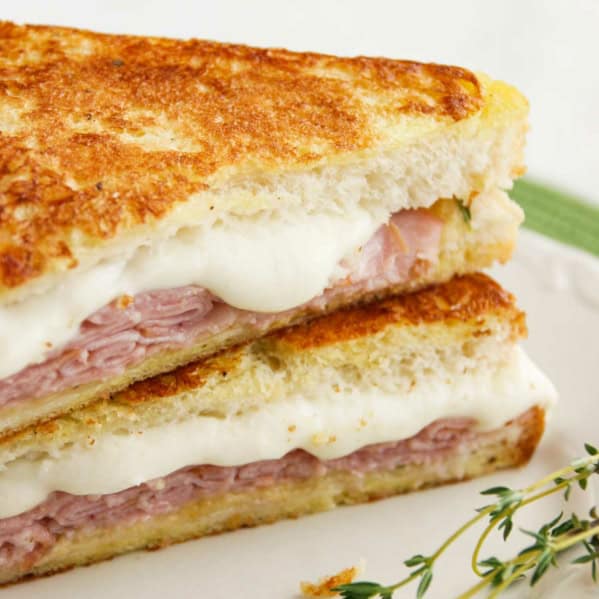 Italian Style Monte Cristo with honey mustard thyme sauce cut in half.