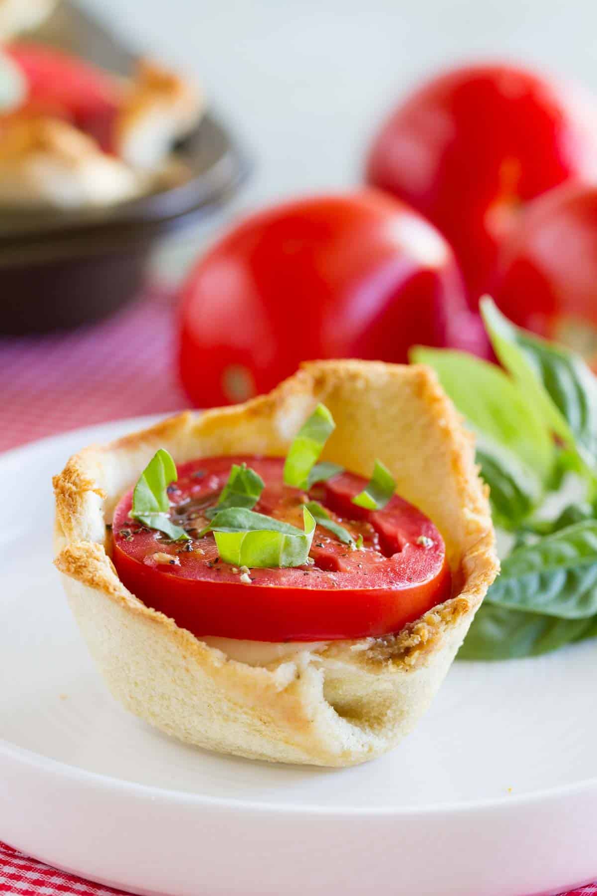 Mini Caprese Tart topped with fresh tomato and basil.