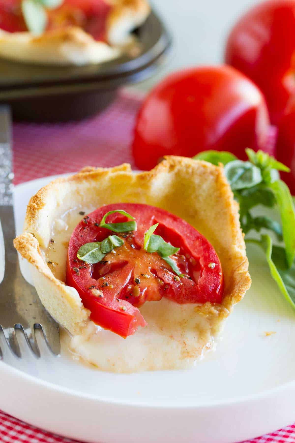 Mini Caprese Tart with a bite taken out of it.