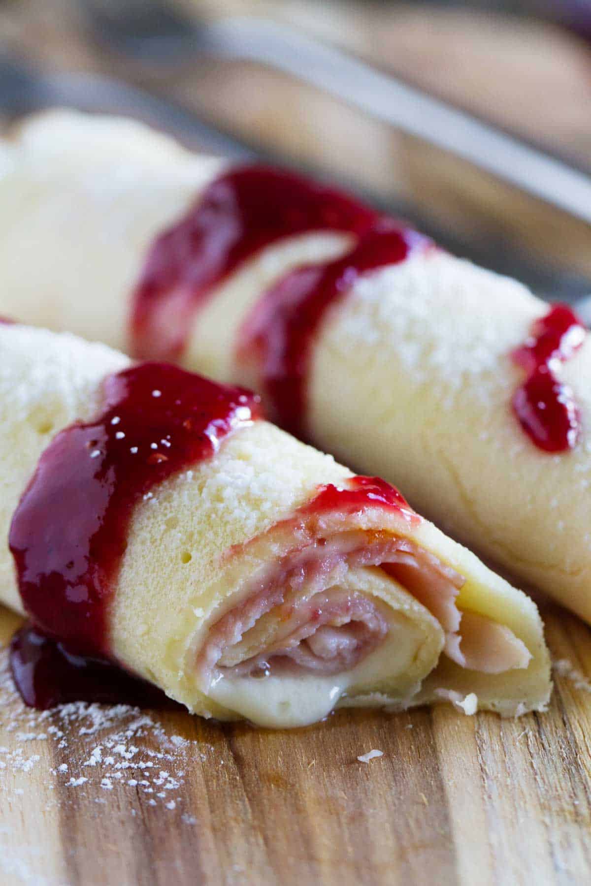 Sweet and savory Monte Cristo Crepes topped with raspberry jam.