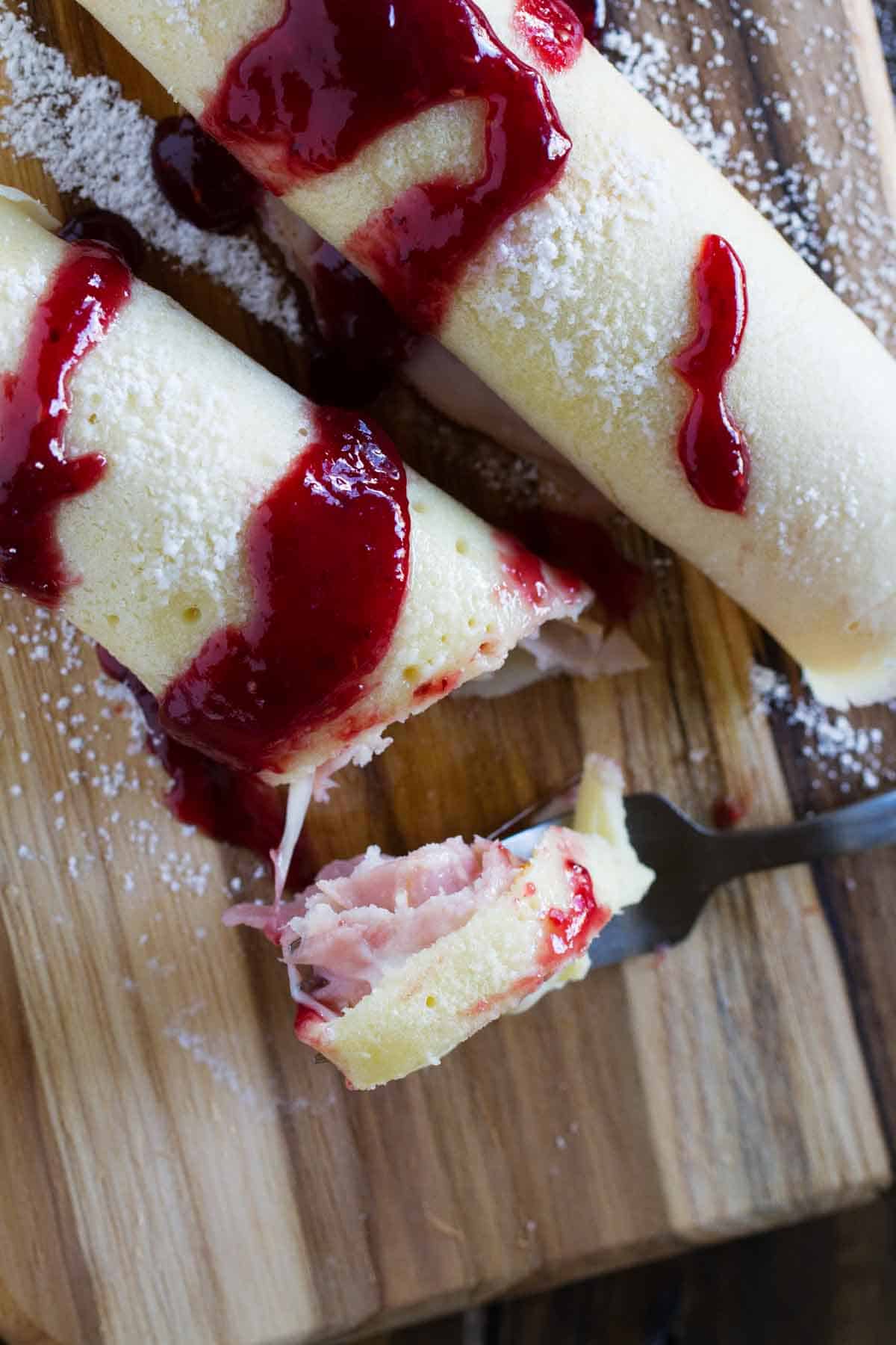 Overhead view of monte cristo crepes with a piece on a fork.