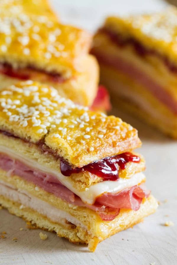 Monte Cristo Sandwich Loaf with layers of meat, cheese, and jam.