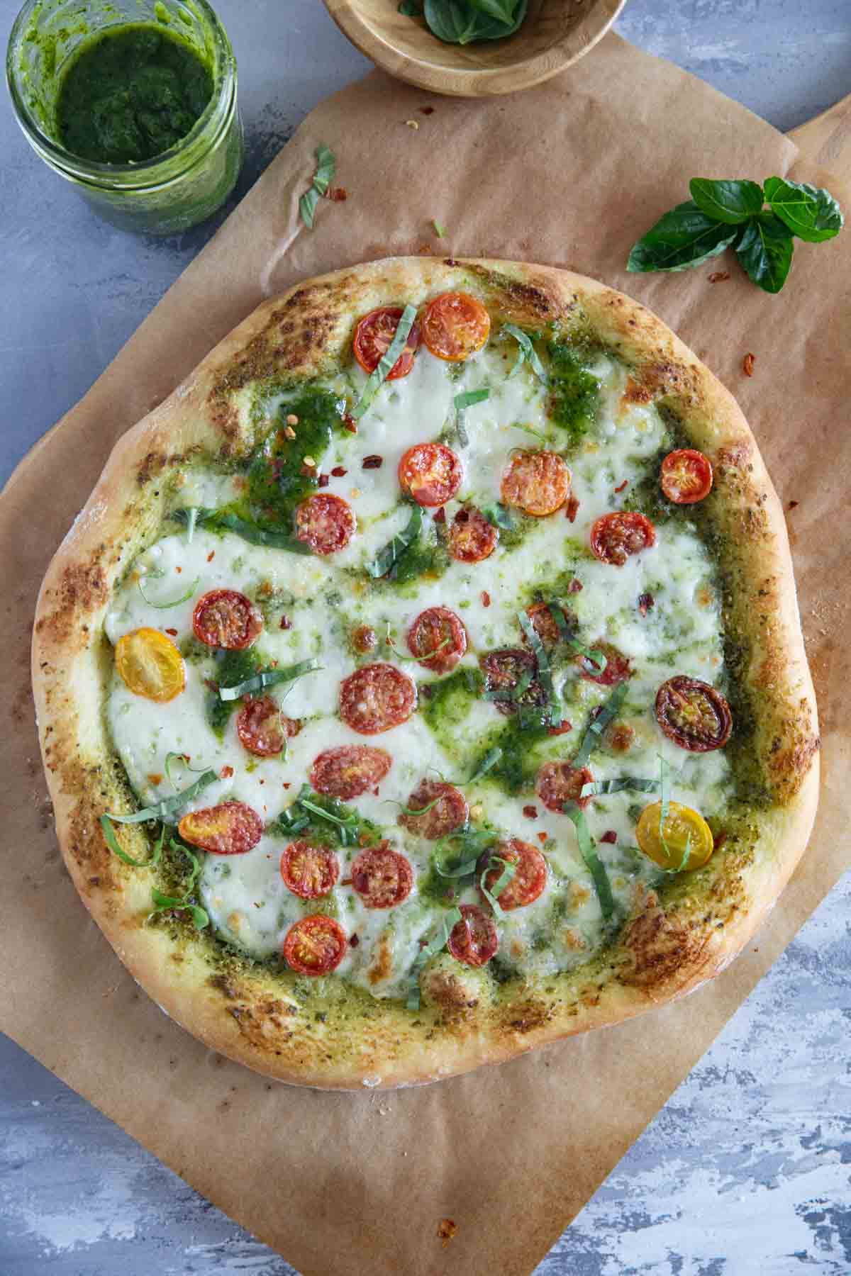 Full pesto pizza with homemade pizza crust.