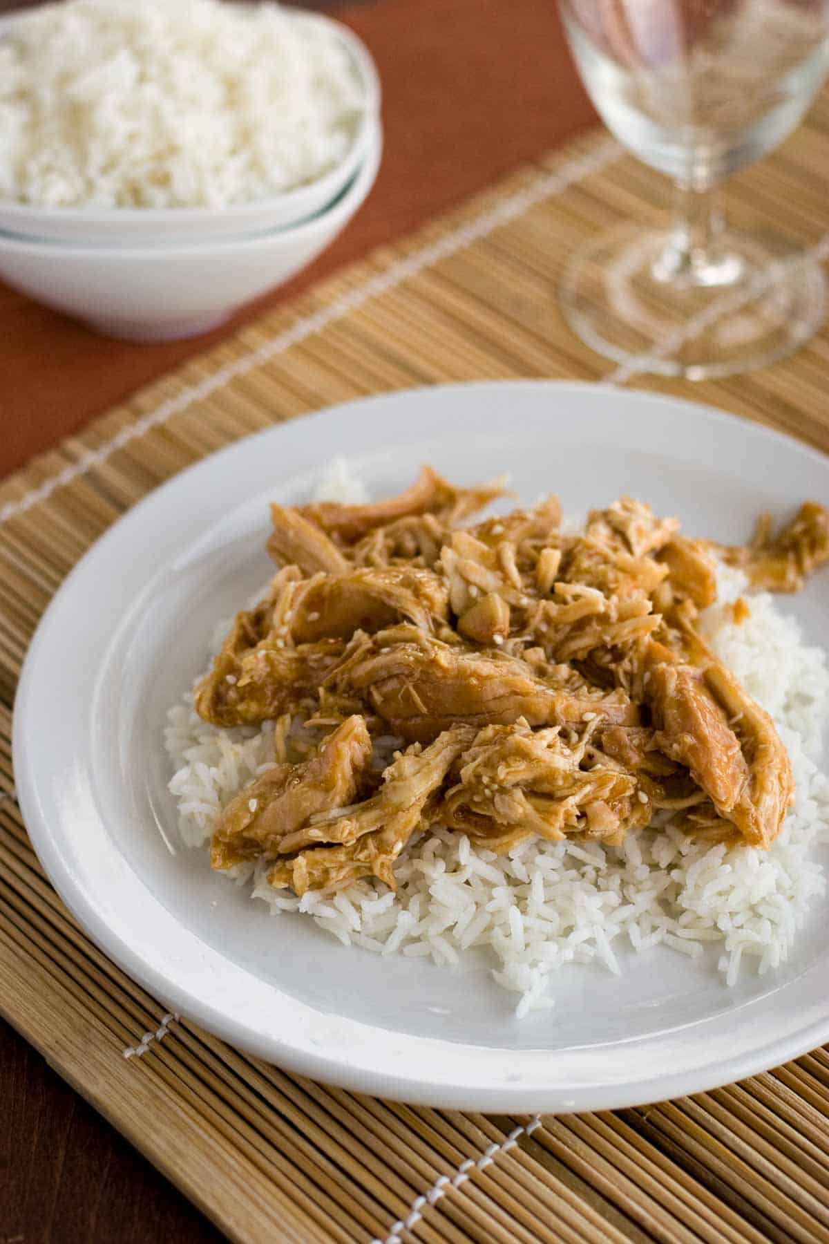 Plate with slow cooker chicken teriyaki over white rice.