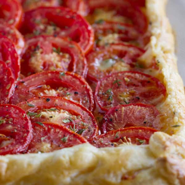 Tomato tart with bacon and gruyere on puff pastry.