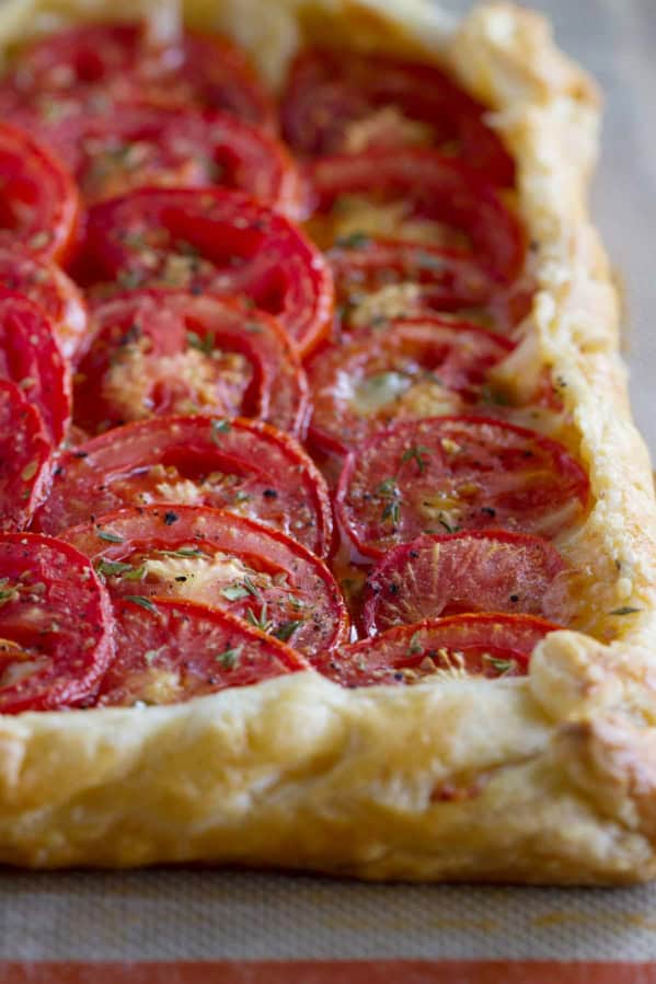 Tomato tart with bacon and gruyere on puff pastry.
