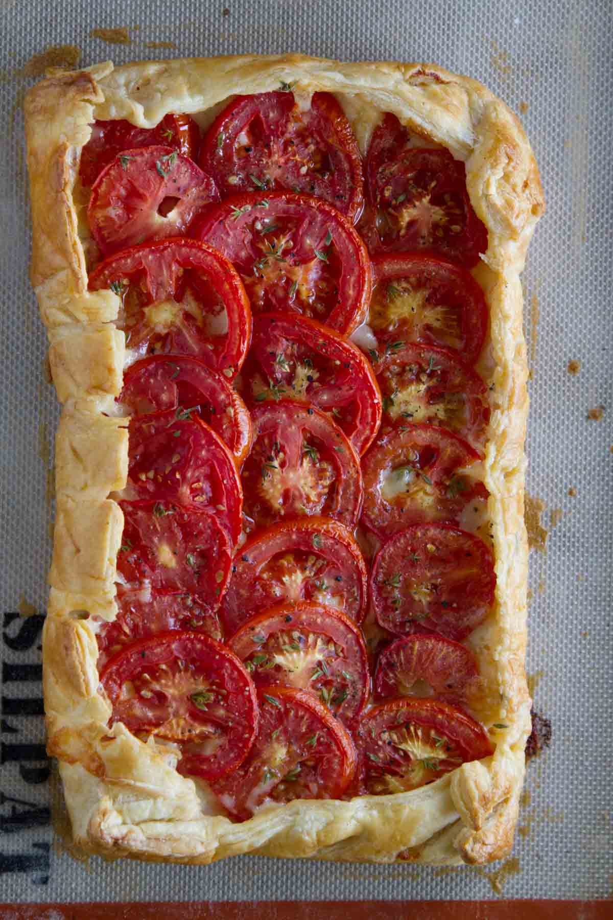 Overhead view of tomato tart with bacon and gruyere.