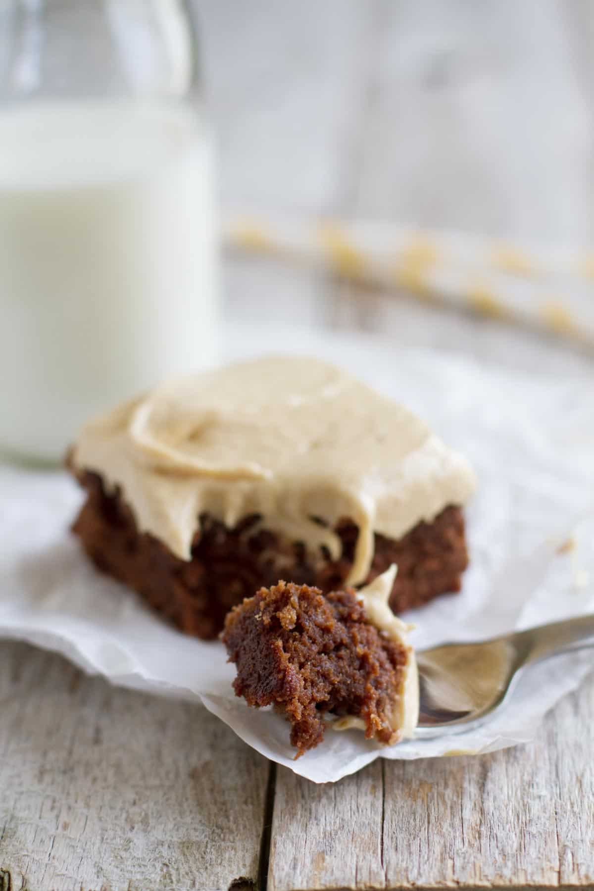 Banana brownie with peanut butter banana frosting with a bite taken from it.