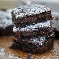 Three cake mix brownies stacked on top of each other.