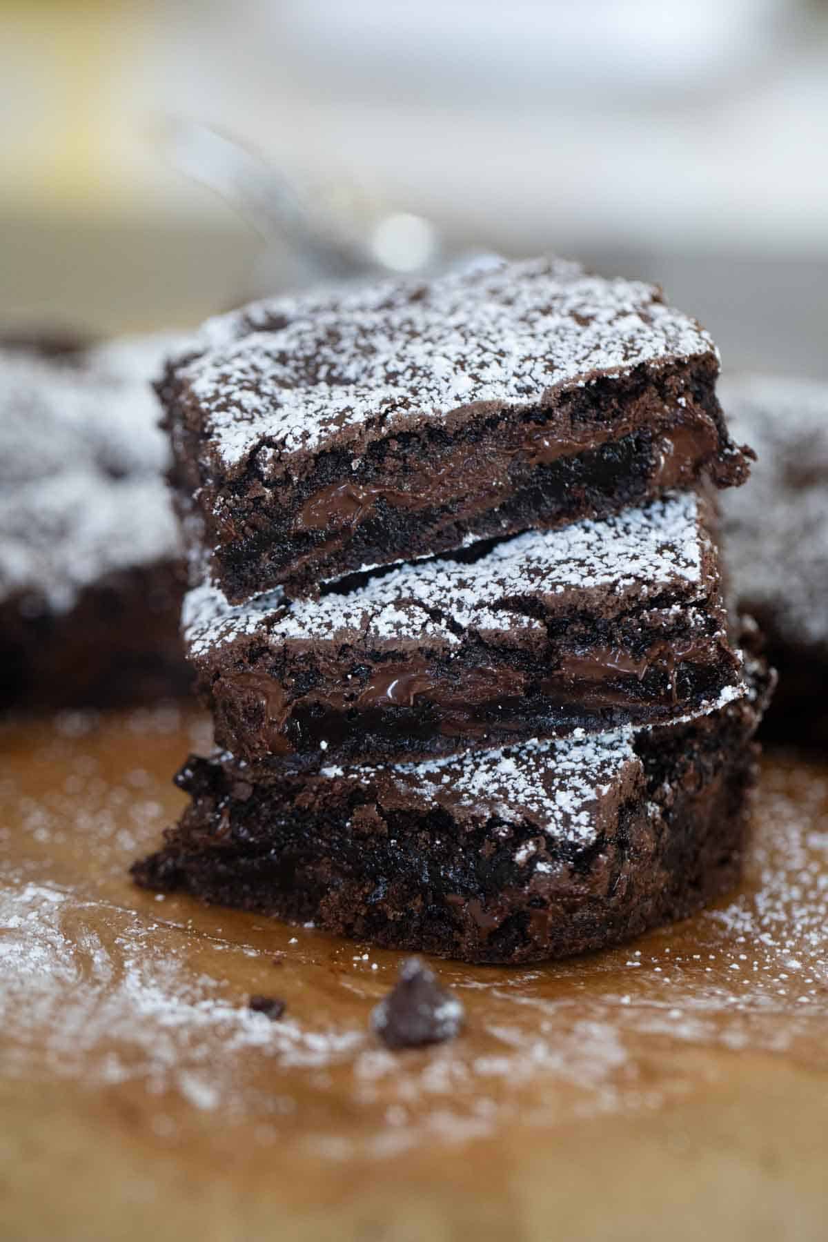 Three cake mix brownies stacked on top of each other.