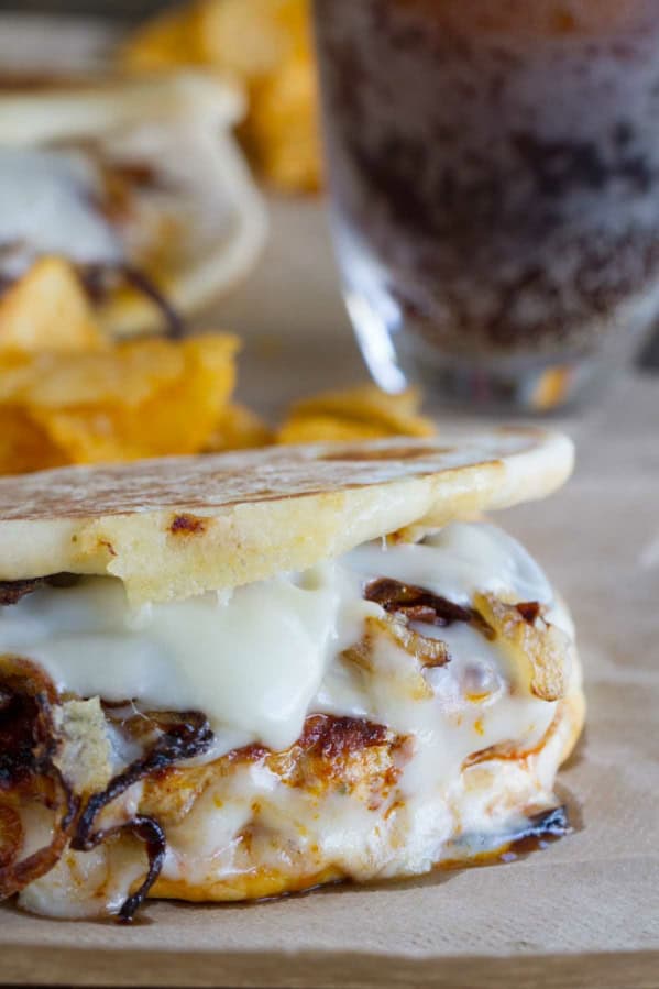 Chicken and Chorizo Patty Melts on flat bread with onions and cheese.