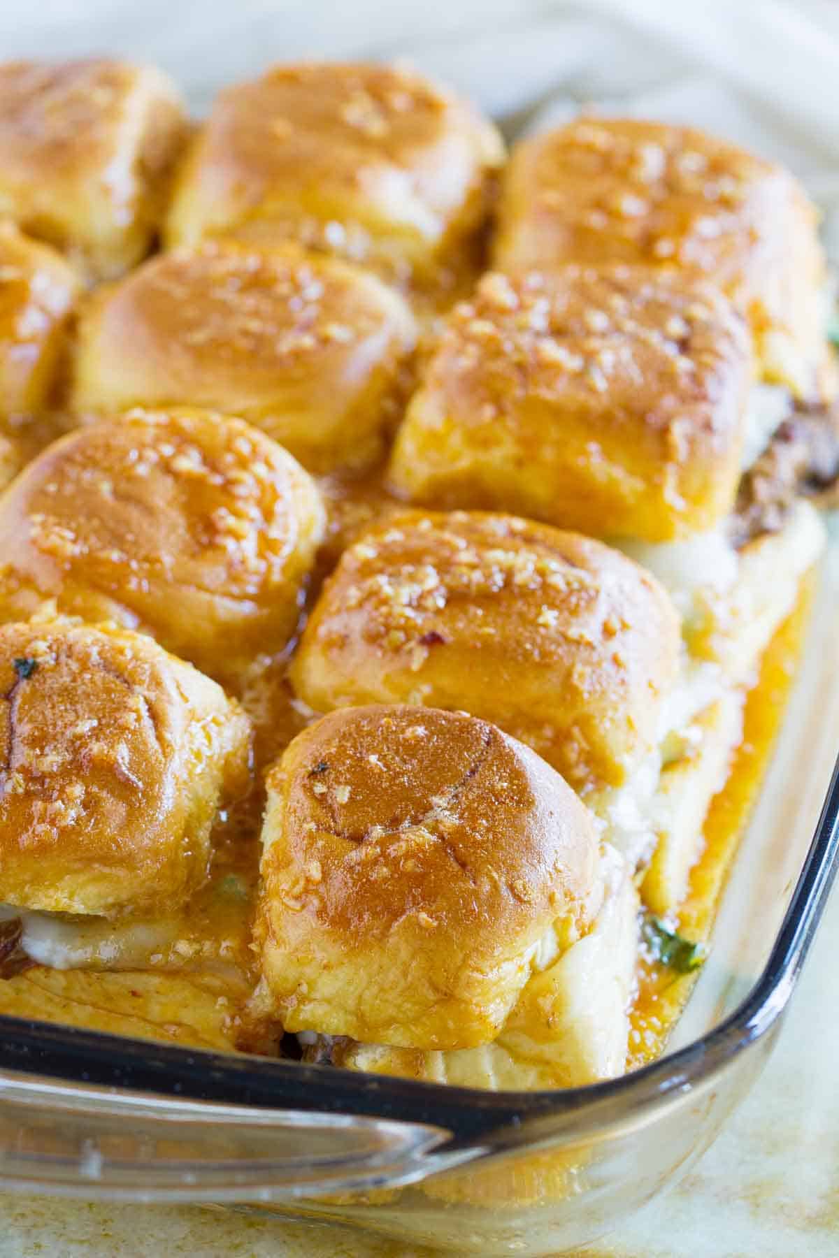 Enchilada Beef Sliders in a glass baking dish.